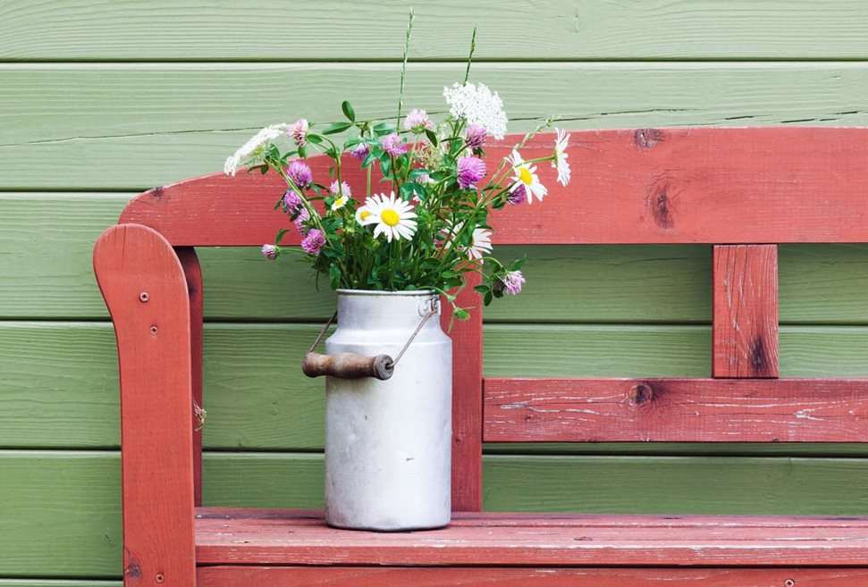 Flowers in vase on red bench