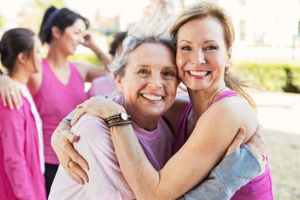 Mother and daughter hugging following running