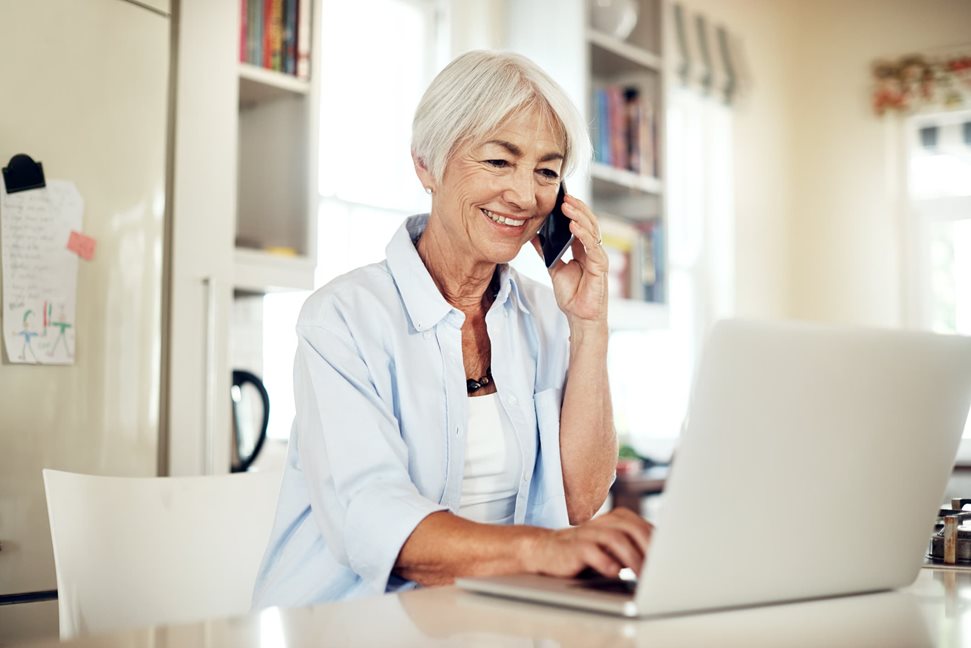 Older woman on a call while on her laptop