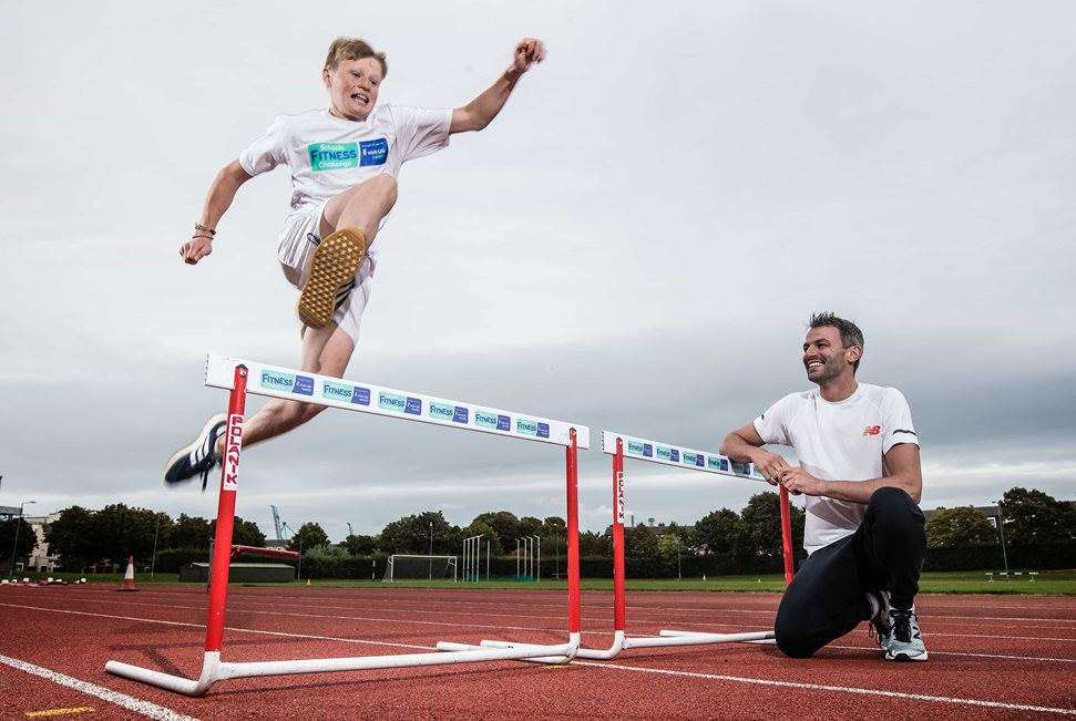 Thomas Barr with young boy at track and field