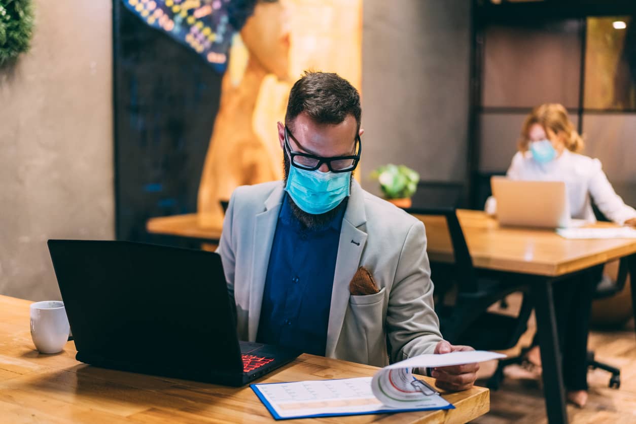 Man working in the office with mask