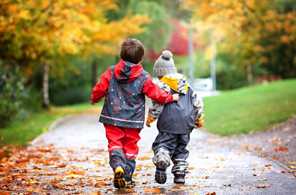 children playing in park in the rain